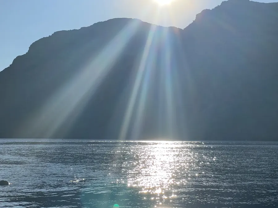 Sonnenstrahlen über Bergen und See